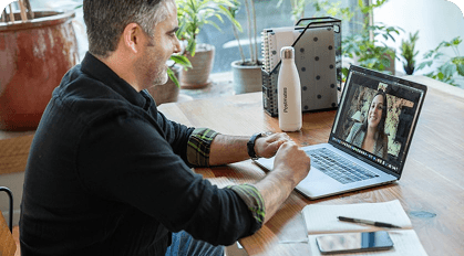 Person having an online meeting on a laptop